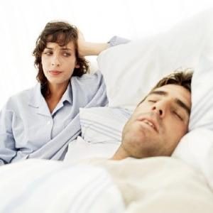 worried woman looking at a sleeping man